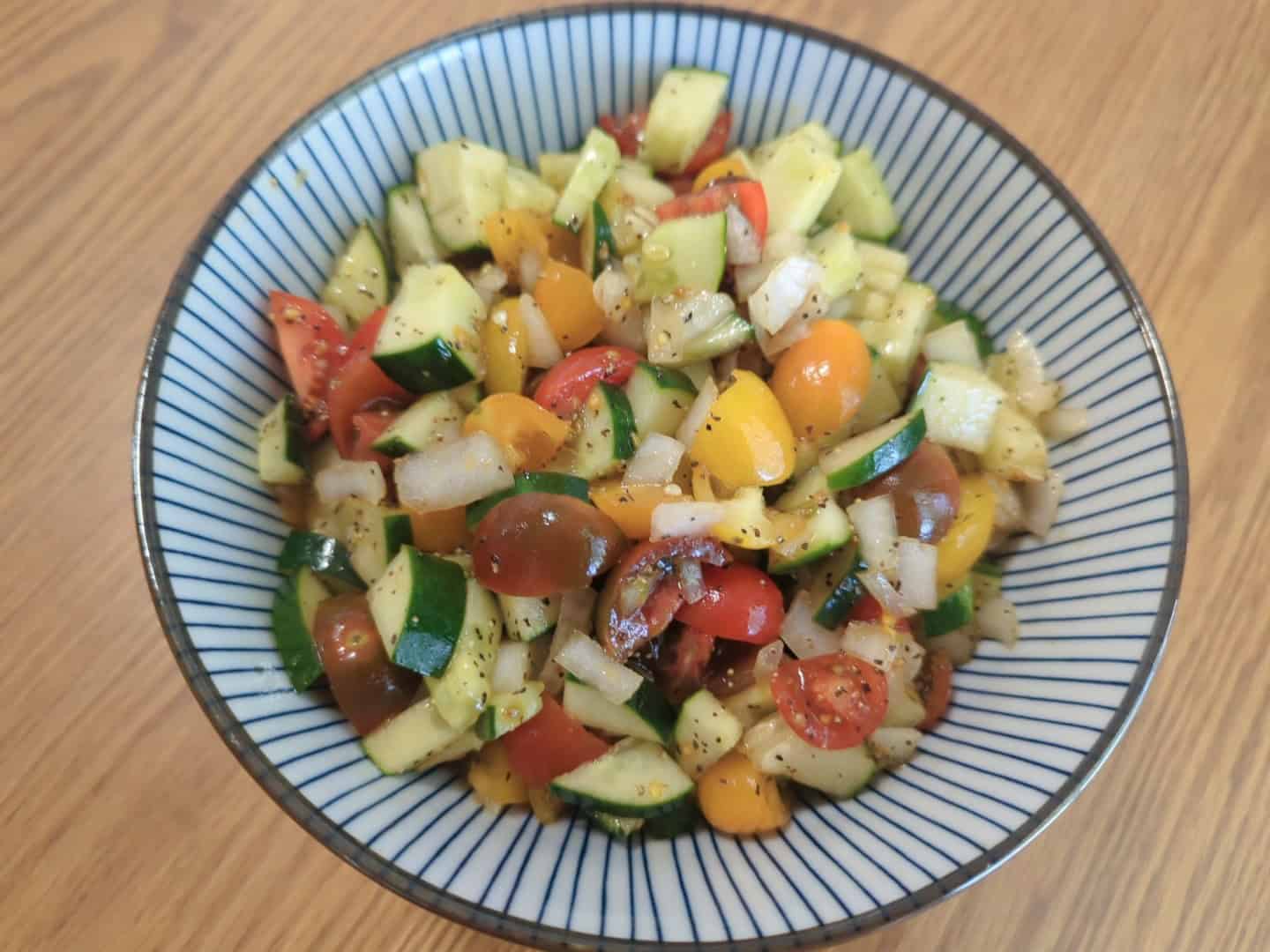 A Vibrant And Brightly Colored Vegetable Salsa In A Porcelaine Bowl, Set On A Wooden Table, Ready To Eat.